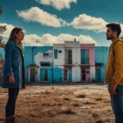 Two people face each other in colorful courtyard.