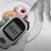 Glucose meter, hand, donuts on plate.